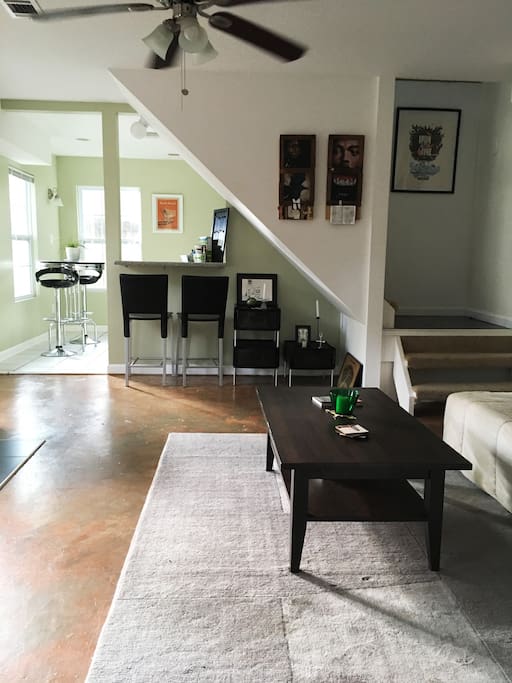 Living room with view of breakfast bar and kitchen dinette (left).