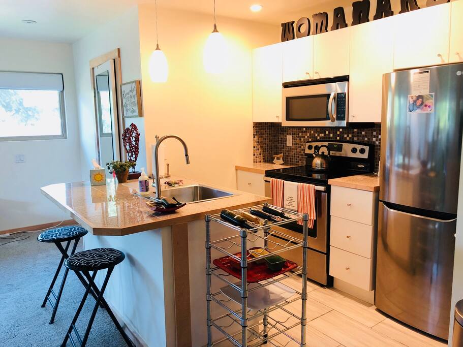 Full kitchen with range, microwave with outside vent, dishwasher, disposal and frig