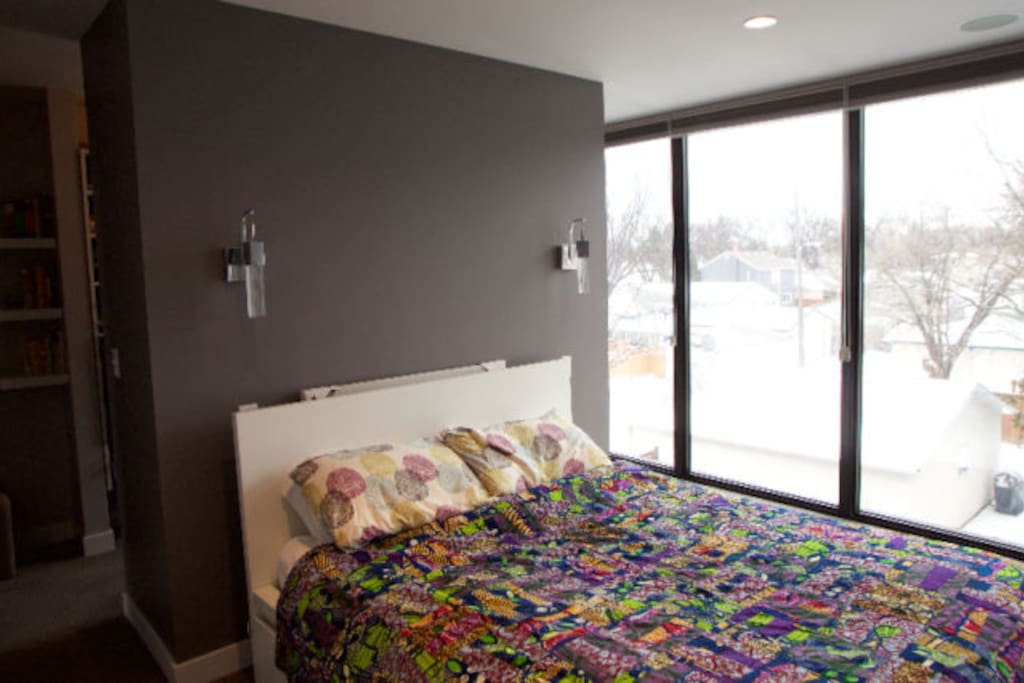 Queen size bed in 3rd floor master bedroom, floor to ceiling windows with blackout blinds