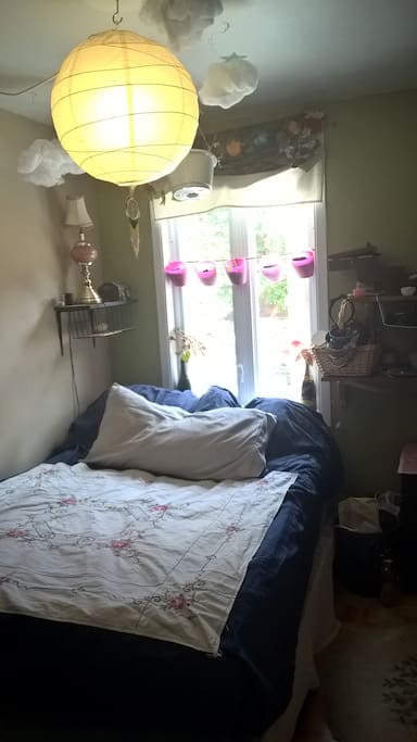 Master bedroom - Double bed with 2 mattress pads for added comfort. Lamps and candles for mood lighting. Hanging herb garden and decorative plants. Fan, shelving, and clothing racks