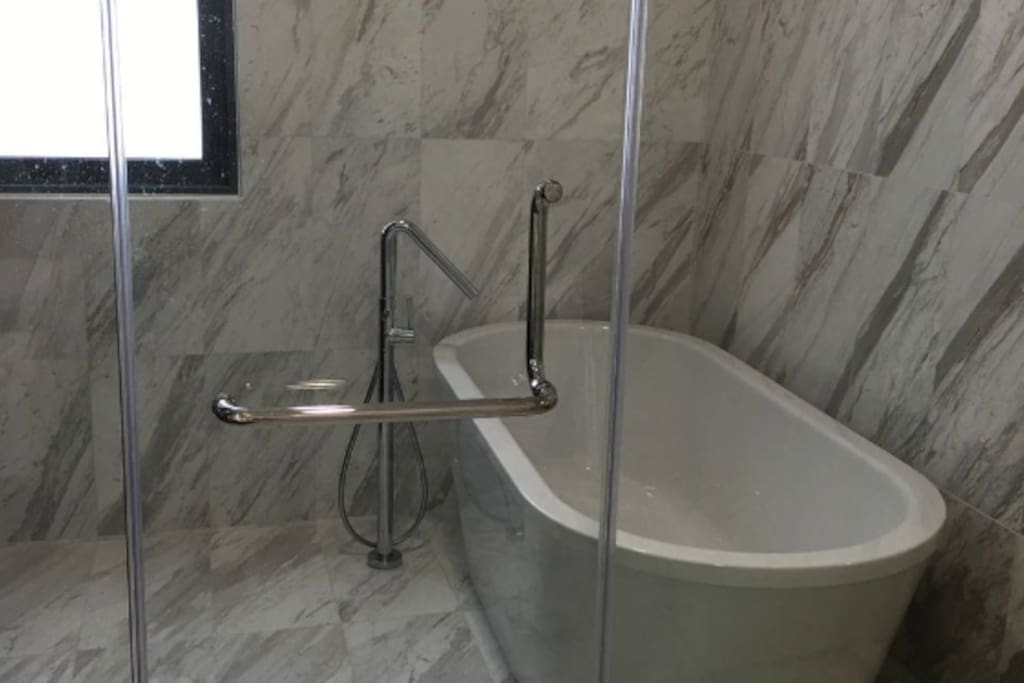 Master bedroom toilet: A deep bath and a shower