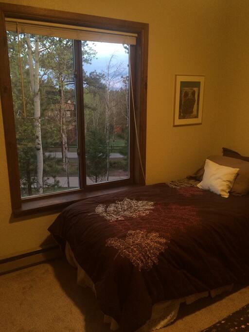 Bed next to window with North West views of nature