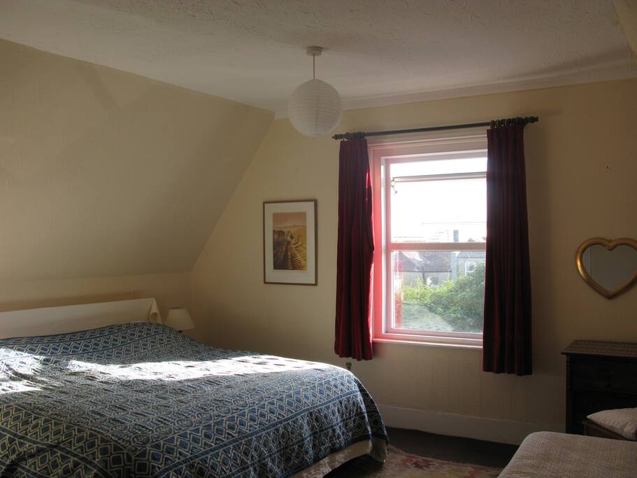 A slant of evening sun across the bed