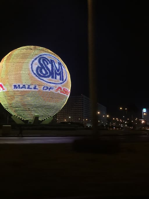 View in front of Shell Residences. The globe serves as an electronic board of the Mall of Asia(MOA). This is a round about (rotunda) and a well known landmark in Manila.