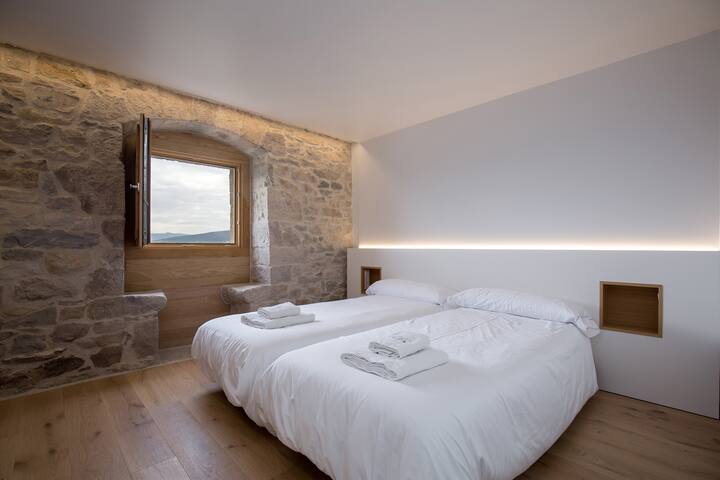 Dormitorio 5: doble con ventana historiada y baño completo.