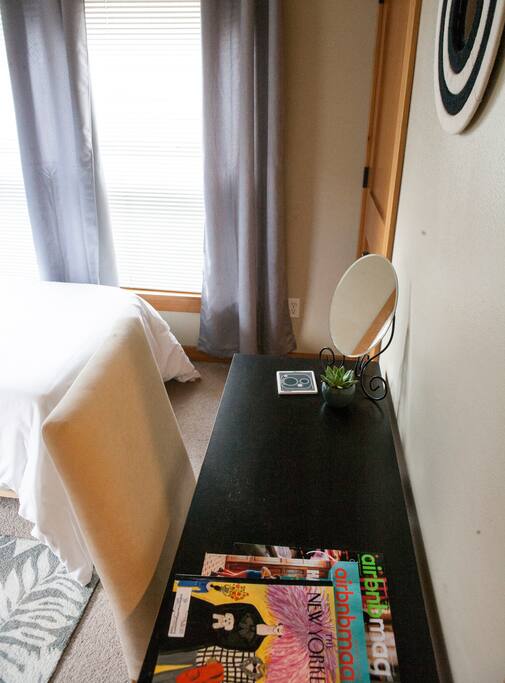 The room's workstation with the latest Airbnb magazine and New Yorker!