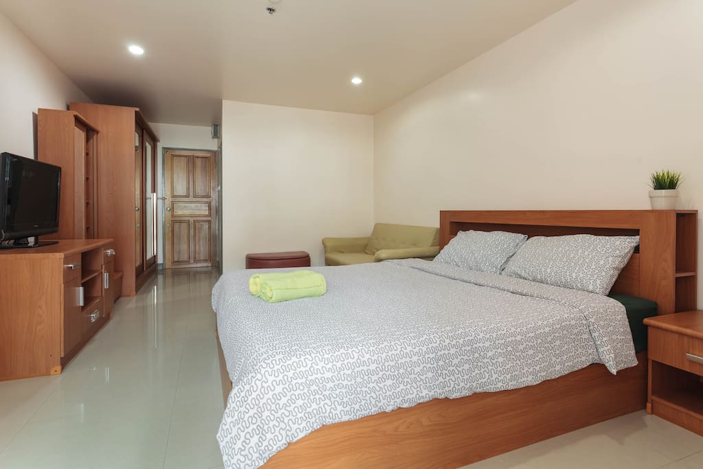 Comfy king size bed covered with soft mattress.