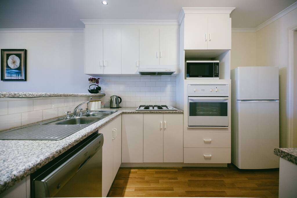 Dishwasher, full size fridge, microwave, oven and gas cooktop