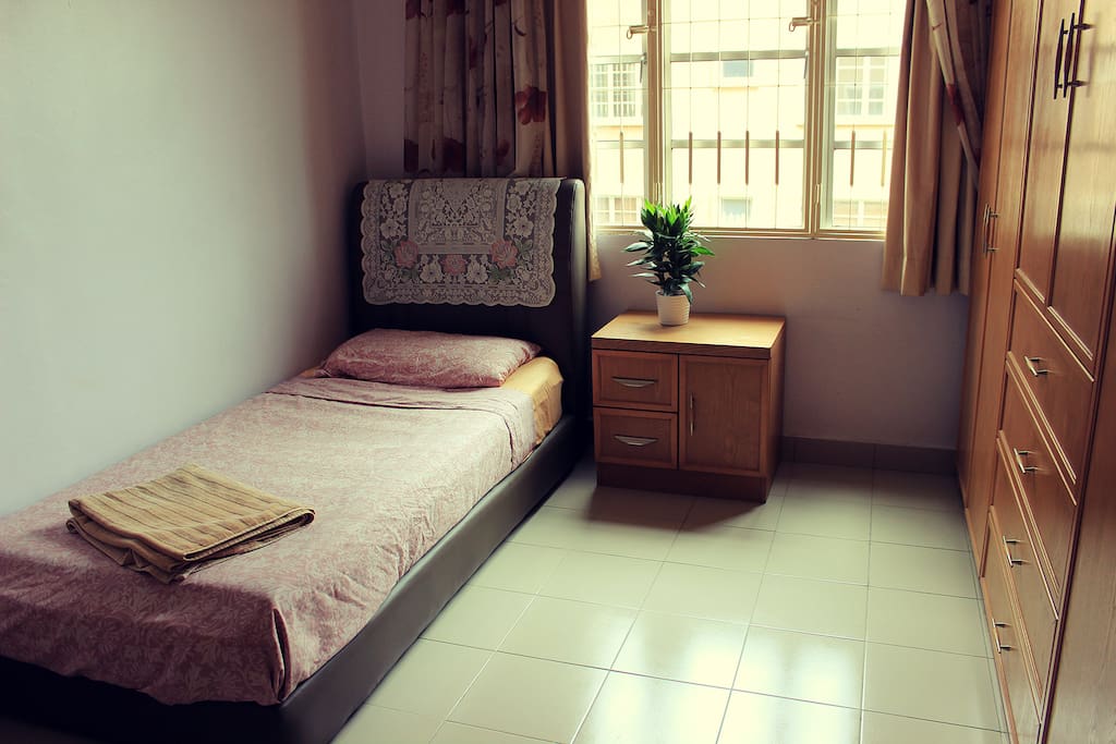 Bedroom with true bed for one person, aircon and fan