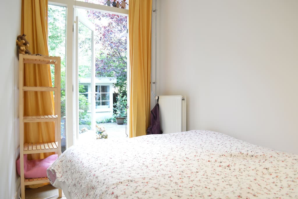 The bedroom has direct access to the beautiful garden