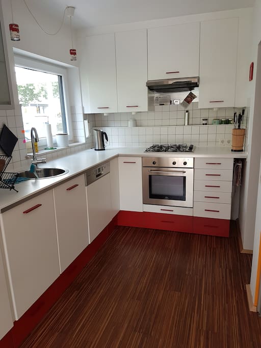Fully equipped kitchen with fridge, freezer, gas stove and electric oven