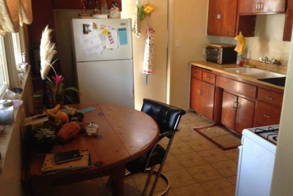 Kitchen. Stove/oven, refrigerator, extendible dining table, toaster oven, coffee maker, large deep sink, stand-alone pantry.