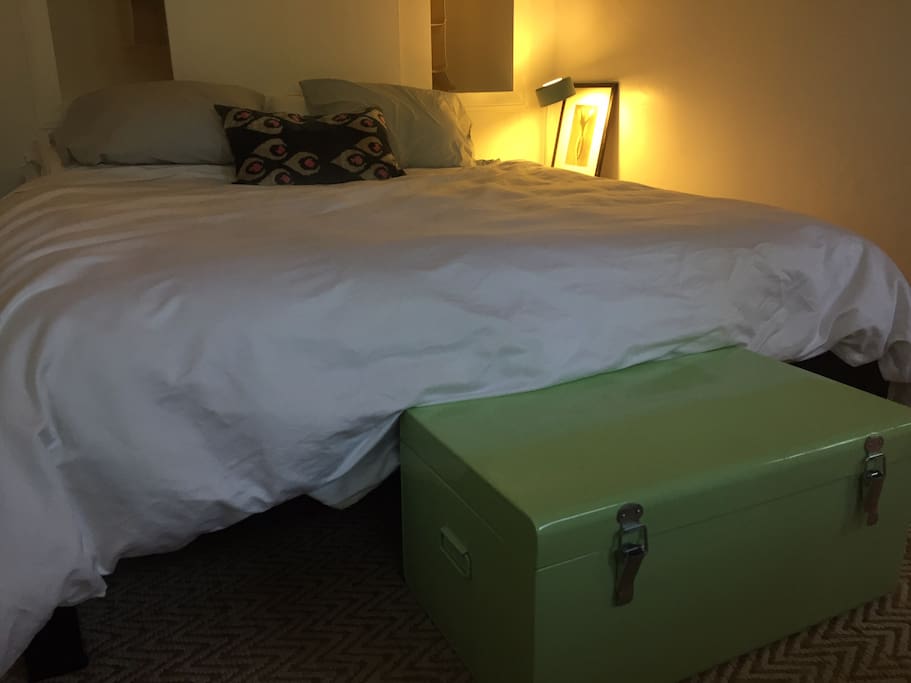 Cozy bedroom with king-size bed, trunk holds extra blankets
