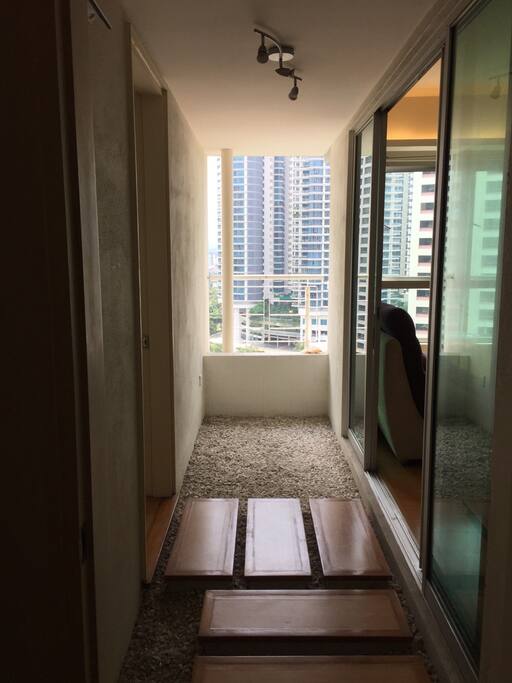 unique open air zen balcony in between bedrooms and living/dining area