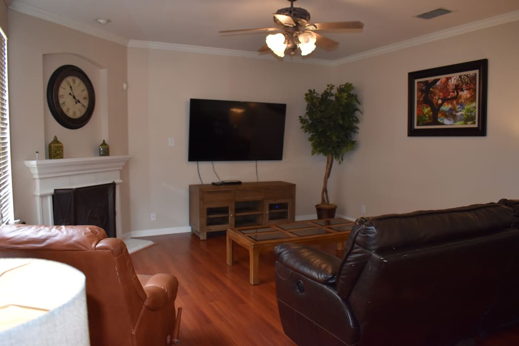 Comfortable living room features leather seating surfaces. 65 inch tv cable and wifi.