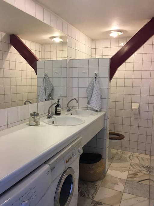 Shared bathroom with shower/bath which is not in view