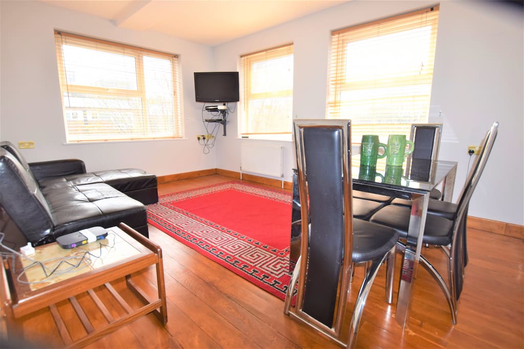 Spacious living room with dining table and TV