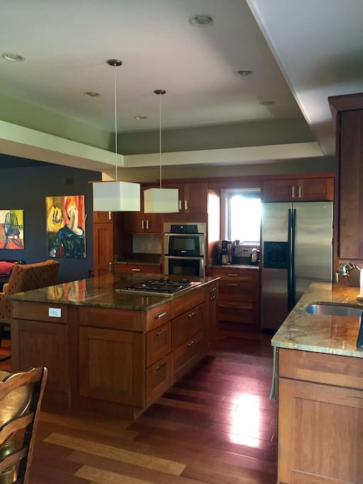 The kitchen is perfect for entertaining and features a counter-top stove, duel oven and microwave, fridge and dishwasher.
