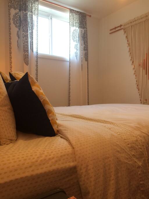 Comfy queen size bed with a large window, you don't even feel like you are in a basement.
