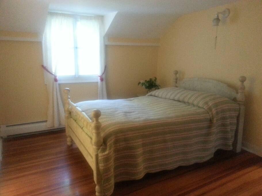 Sunny room with double bed and private bath.
