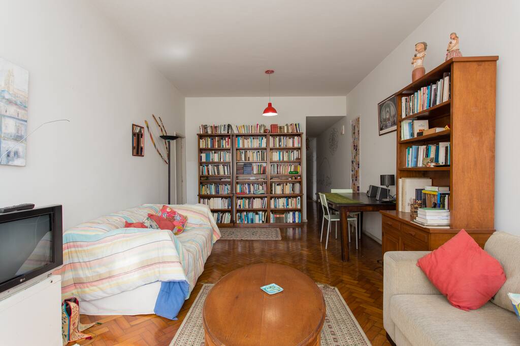 This is the couch with contemporary art on the wall and one more bookshelf