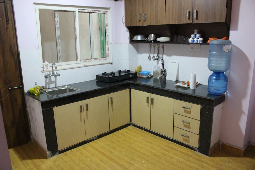 Kitchen with Kithchenwares and stoves (Tiled floored kitchen)