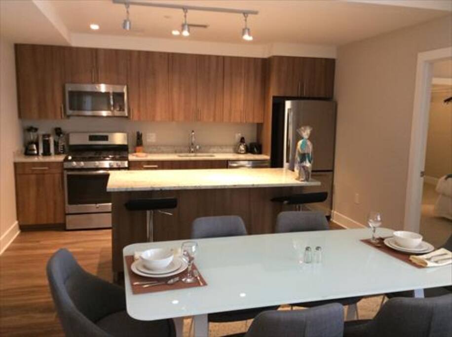 Fully equipped kitchen with full size appliances, pots, pans, and dishes.