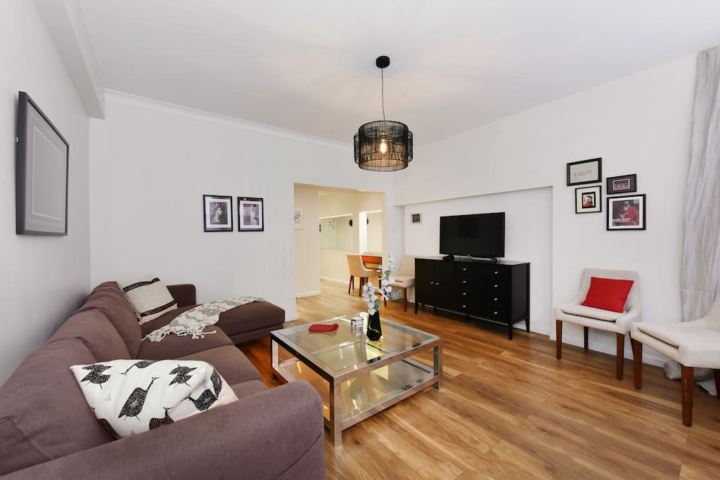 The attractive interior-designed Lounge with large L shape sofa, TV, Freeview, Free WiFi and large windows