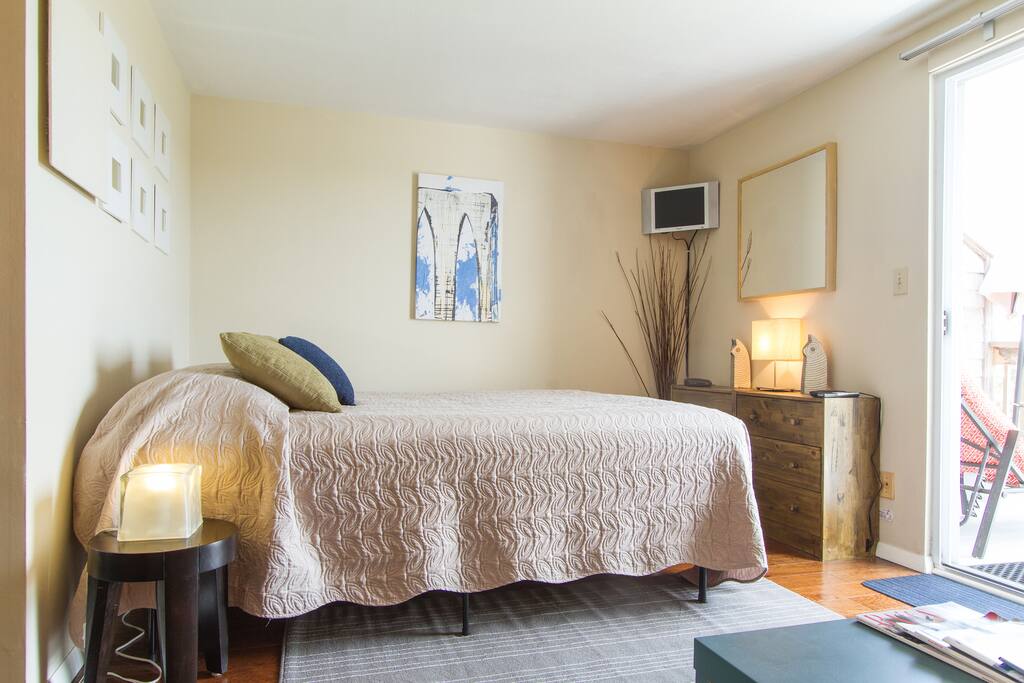 The comfortable queen size be looks out to your private outdoor deck.