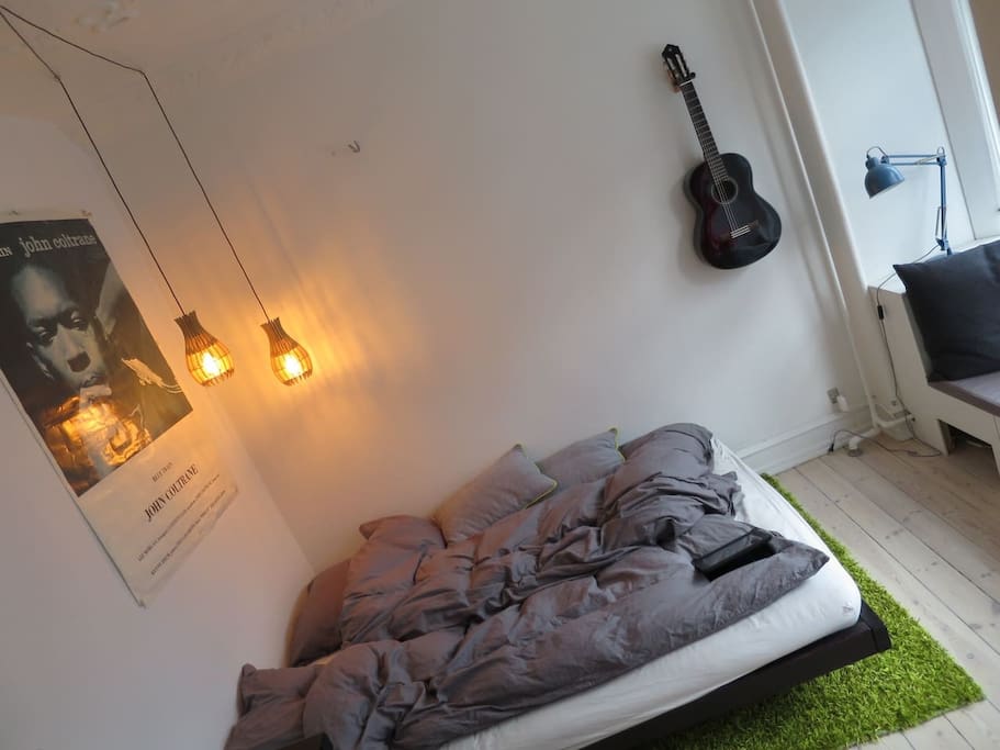 Japanese bed with futon mattress. Spanish guitar, cosy light and John Coltrane with his saxophone