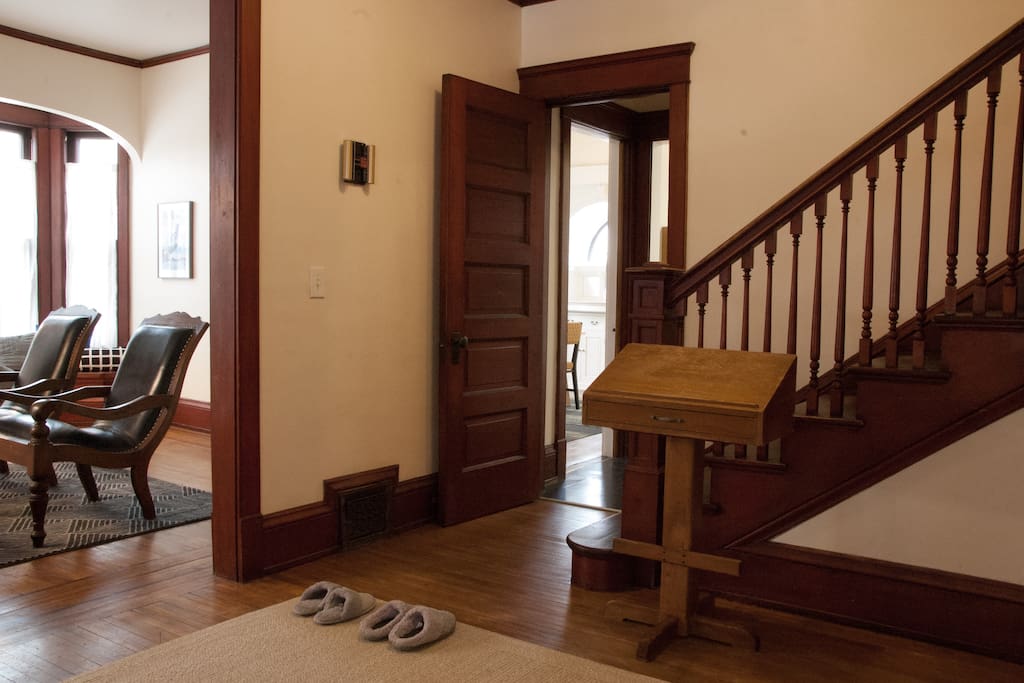 Entry foyer with original woodwork and guest slippers