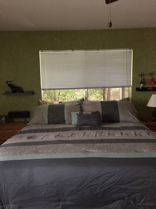 Blue tooth speaker and electronic connections to left of bed.