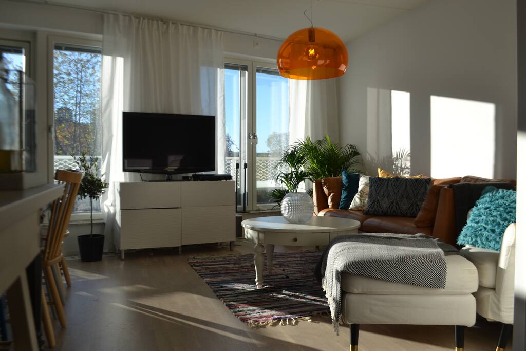 Spacious living room connected to kitchen and balcony - very social setting!