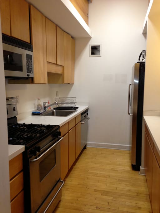 Kitchen view with new appliances, a peninsula to prepare food, and more.