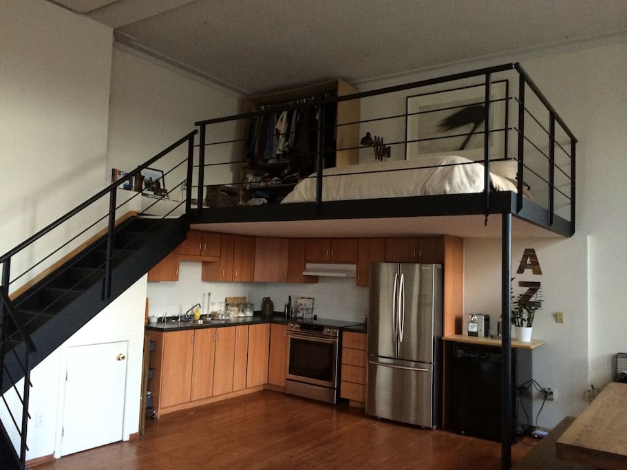 Another angle at the kitchen and mezzanine with queen bed