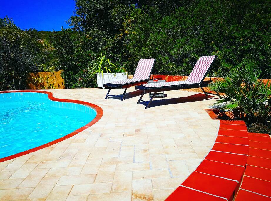 Piscina privata con comode sdraio e tavolino