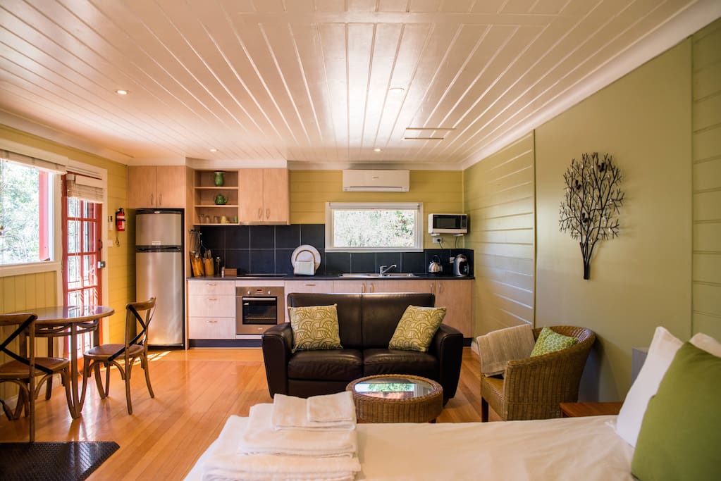 Looking from the bed into the living area and kitchen