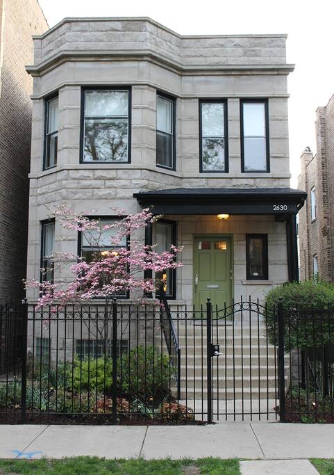 Front of the building in the spring. (Updated photo showing the new black porch awning. We keep painting the front door different shades of green, but we'll settle on one eventually...)
