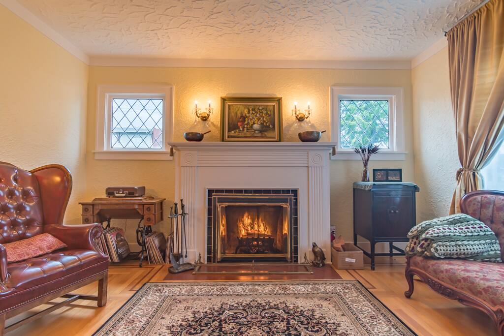 Olympic Homestay: Fireplace, record player, games, books, and HEOS stereo system.