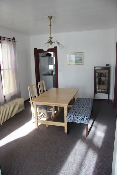 Dining room with wooden table with an extra leaf to add more space if needed (not pictured)