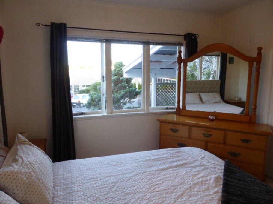 Bedroom photo, light and sunny. Comfortable queen bed, plenty of bedding, lots of room in the wardrobe to hang your clothes and fill the draws.