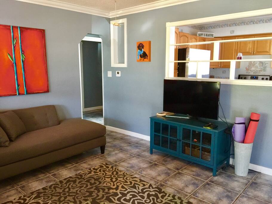 Smart TV with Sling TV, DVD player with a selection of movies, plenty of seating, and yoga mats for poolside yoga!