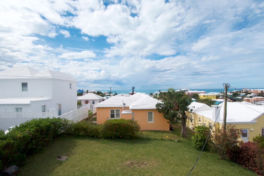 From the second story window you get a great view of the back garden, Bermuda's pastel homes, and the Atlantic Ocean. If you look carefully, those blurry patches above the orange house are rain falling in the distance. It was a typical Bermuda day, torrential "Tank" rain followed by the most Bermudiful day literally 10 minutes after