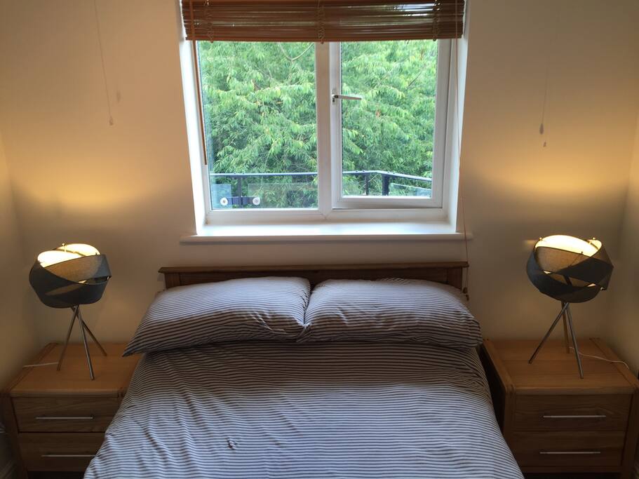 Lovely double bed with bedside tables and table lamps