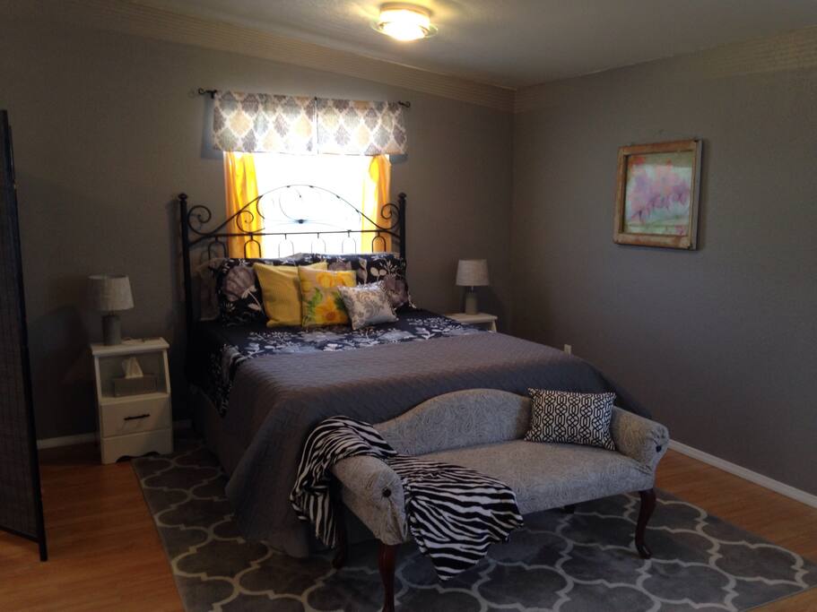 Queen size comfy bed with lots of pillows.