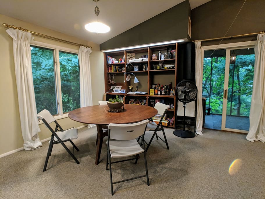 Dining area with games, books, and seats for up to eight. You are welcome to borrow books during your stay.