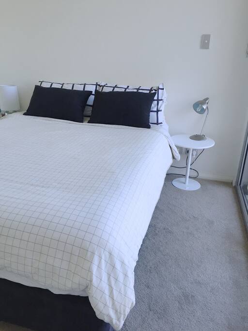 Queen Size bed with two bedside tables and lamps. Plenty of sunshine all day. Room comes equipped with blinds.