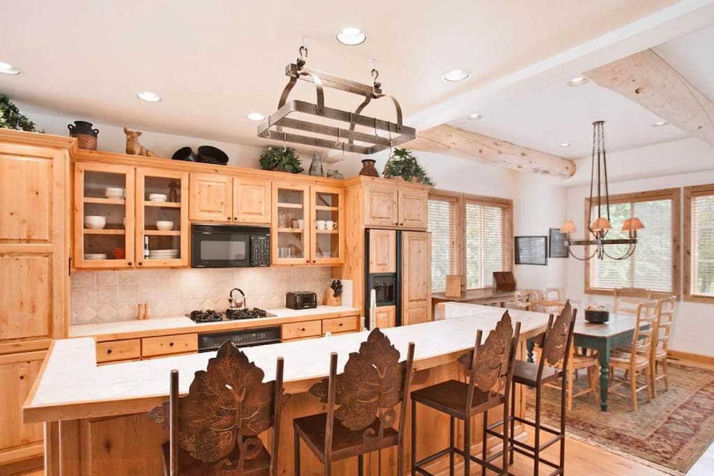 Gourmet kitchen with large dining island with 4 stools