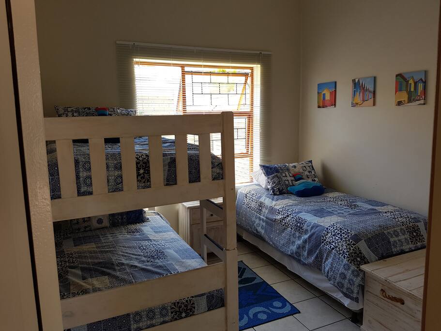 Second bedroom with single bunk beds and a single bed.