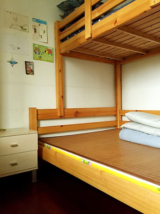 A double-decker bed, 3 people could have a good sleep.